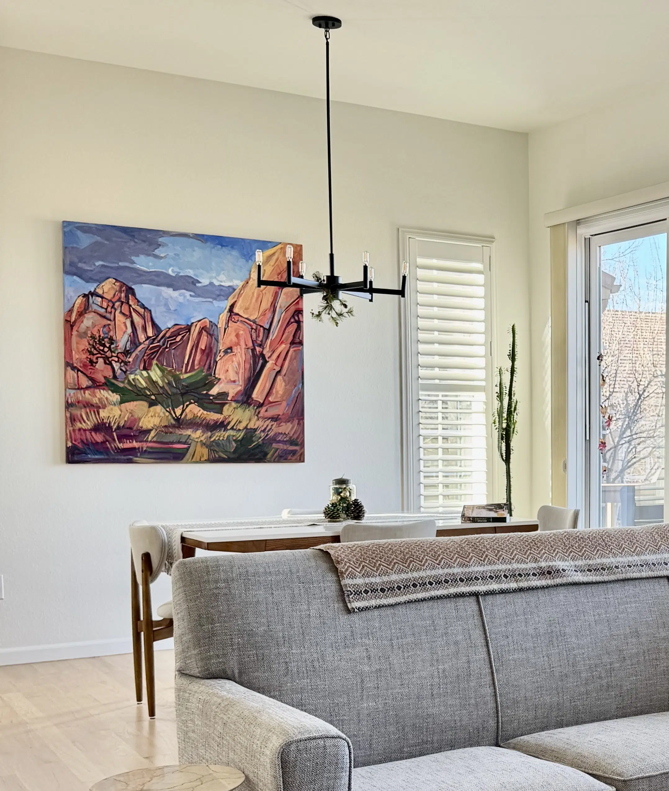 An open concept living room and dining room feature SW Alabaster walls, the foundation of a SW Alabaster color scheme.