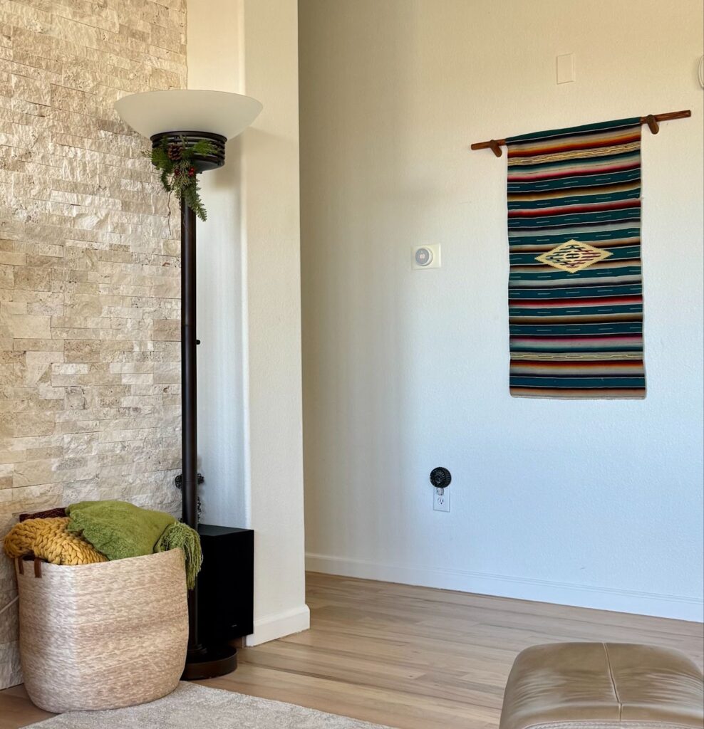 An open concept living room and hallway feature SW Alabaster walls, the foundation of a SW Alabaster color scheme.