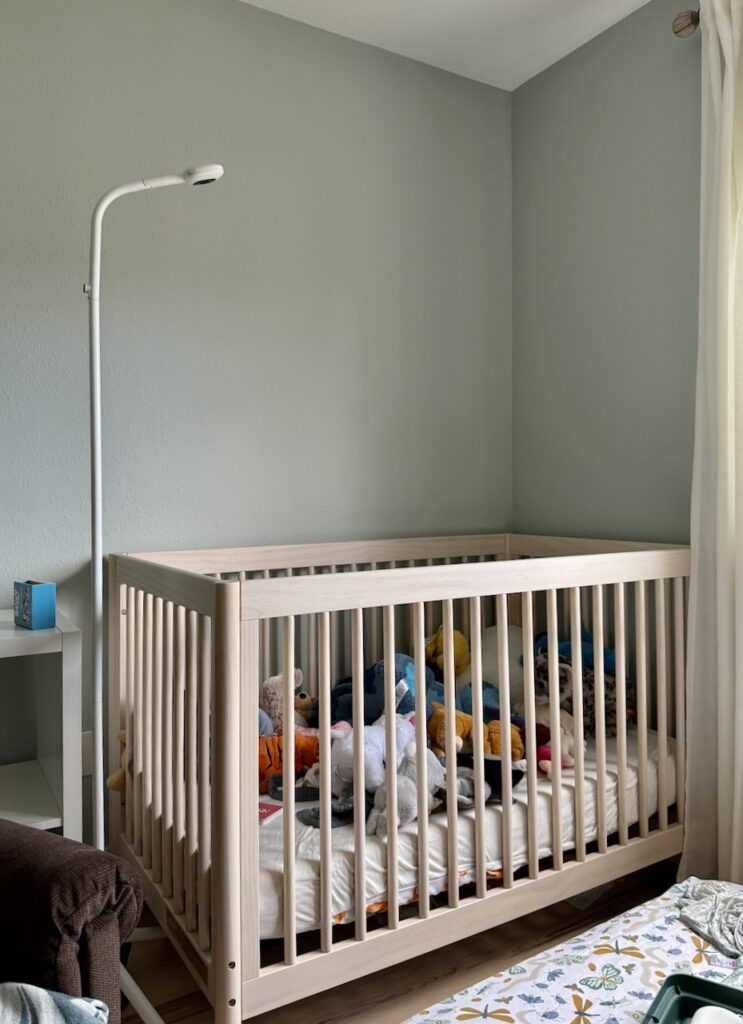 A nursery features SW Quiet Moments paint, a cool green paint color.