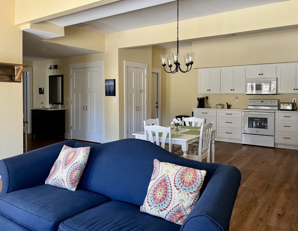 An open concept living and kitchen features BM Cornsilk interior paint. 