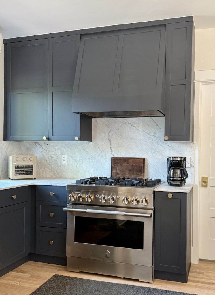 A modern black and white kitchen color palette features BM Witching Hour cabinets and SW Shoji White walls. 