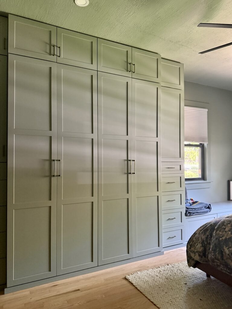 A built-in cabinet painted with SW Evergreen Fog, one of the best green paint colors on the market.