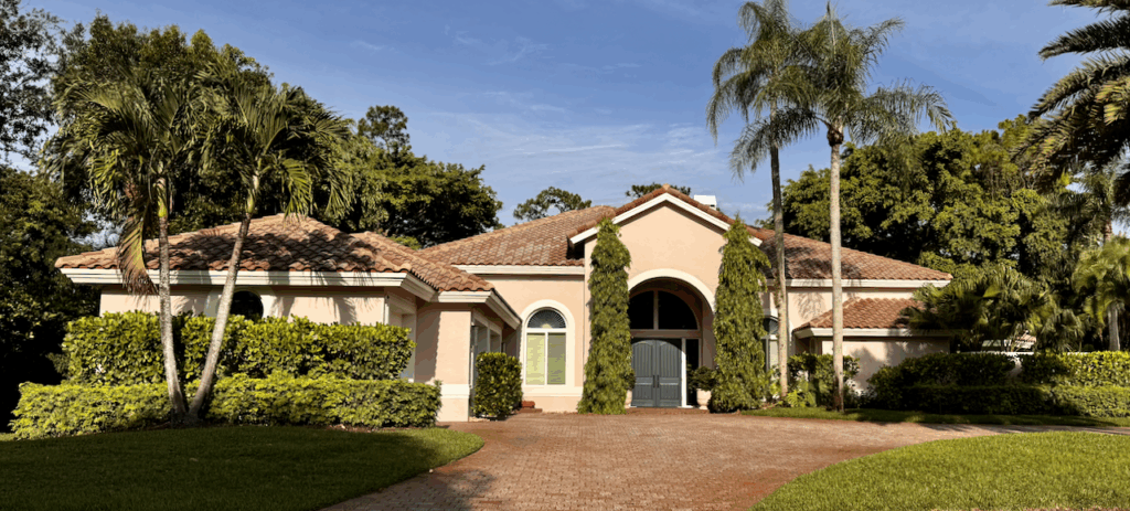A home features a pink stucco exterior paint color palette. 