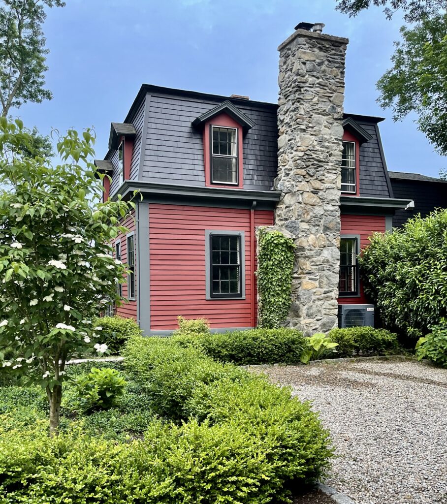 SW Rustic Red Exterior with Gray Stone Chimney