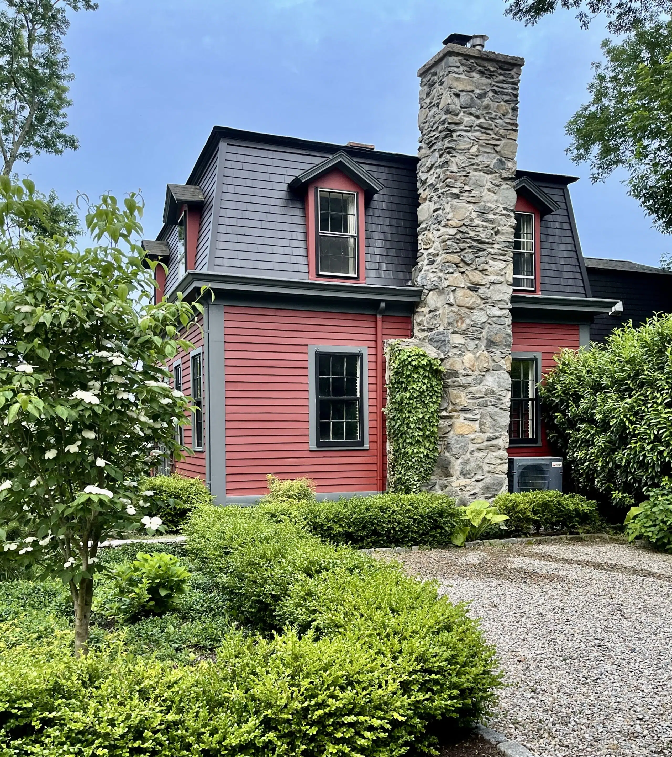 SW Rustic Red Exterior with Gray Stone Chimney
