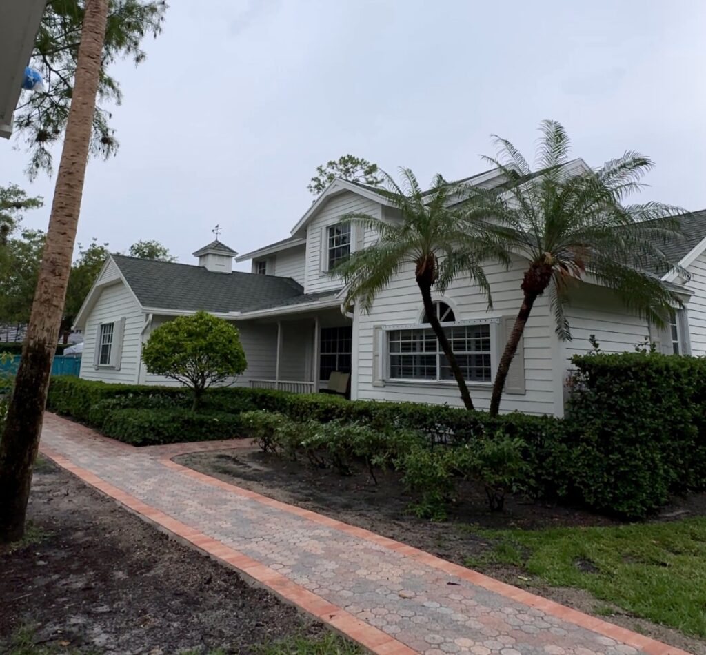 A Florida home features a BM Swiss Coffee exterior paint color palette.