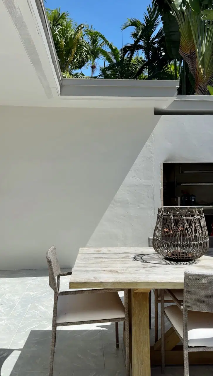 A courtyard is painted with SW Origami White. Read our full paint color consultant review of this exterior paint color.