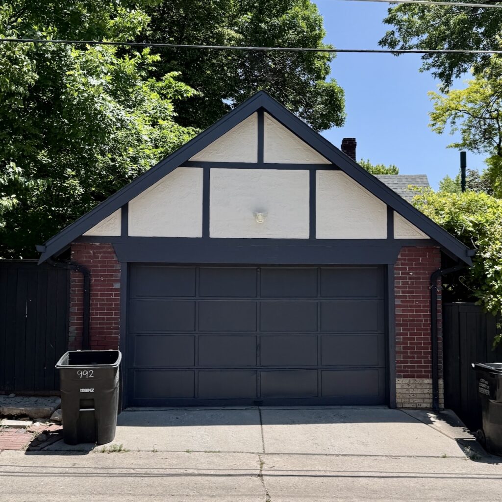 A Tudor garage features a modern Tudor exterior paint color palette.