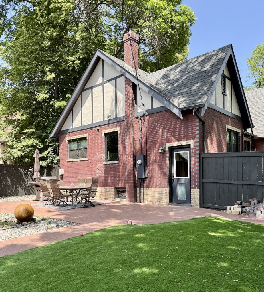 A Denver home features modern Tudor exterior paint colors, including SW Cyberspace exterior trim. 