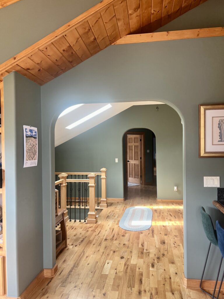 A home features BM Cambridge Green paint in an open concept living area. 