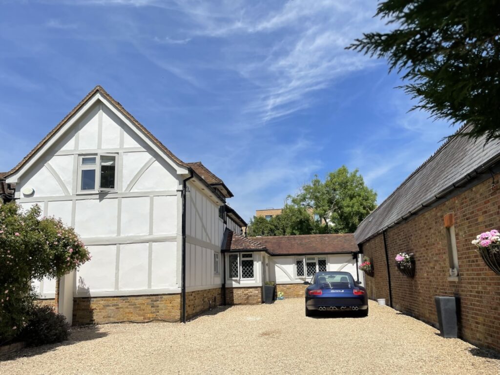A Tudor-style house exterior in England, showcasing a more modern Tudor color palette.