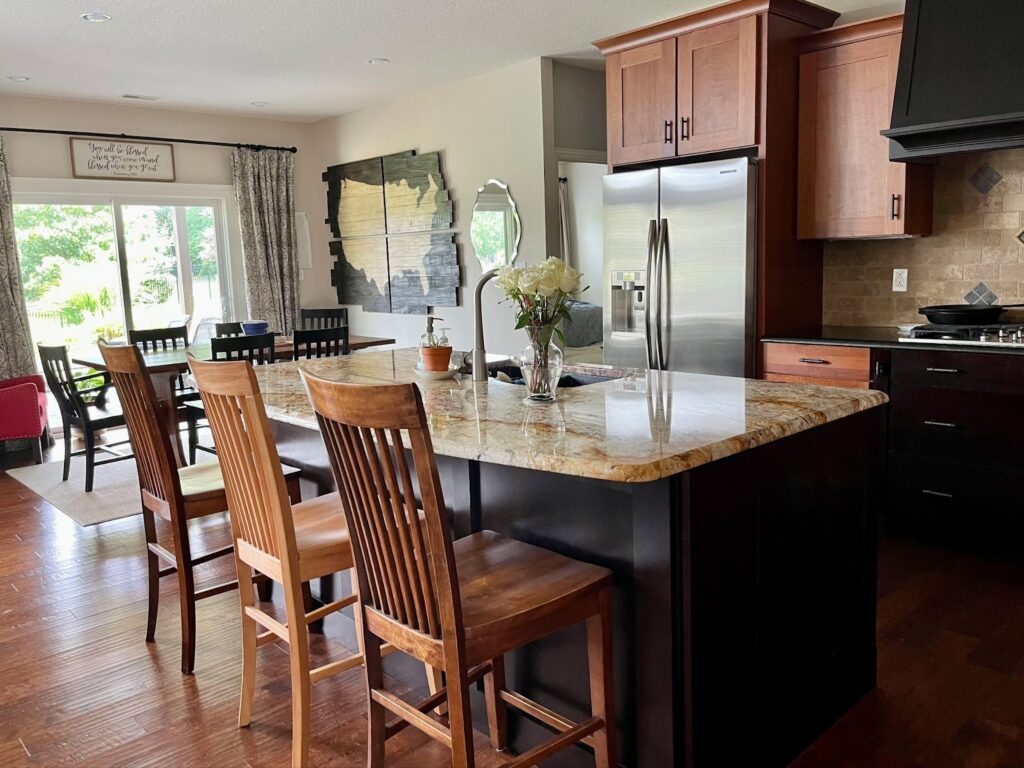 A SW Natural Linen kitchen with wood cabinets and warm granite countertops.