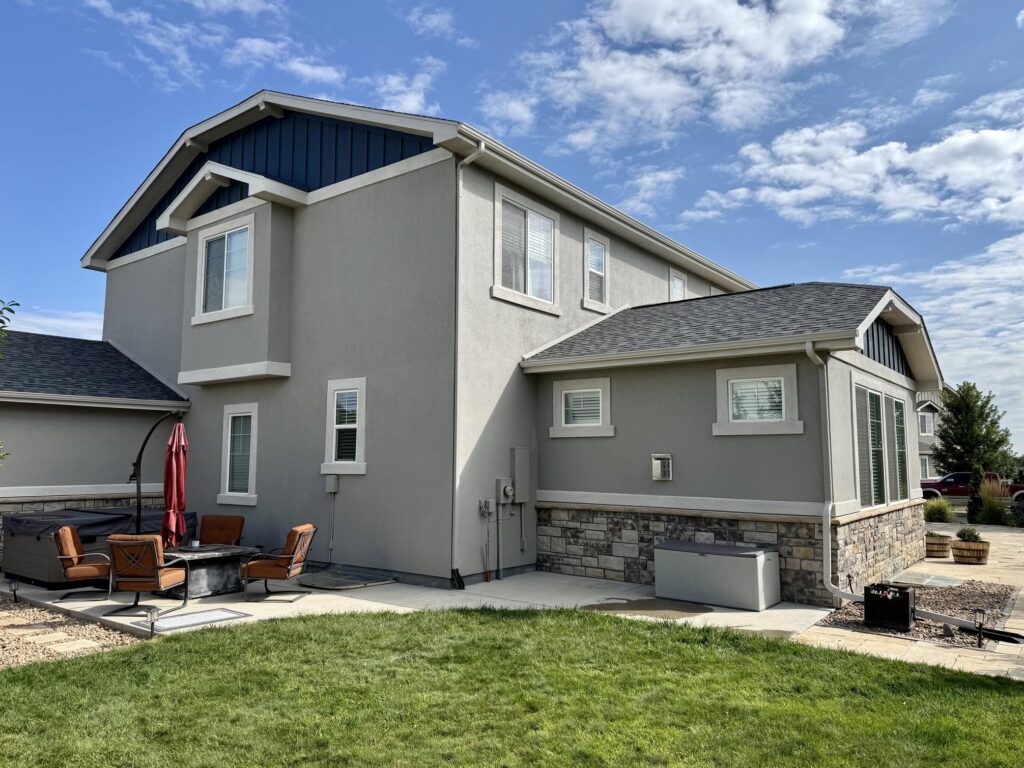 A home features SW Dorian Gray siding and SW Sea Serpent board and batten gables.