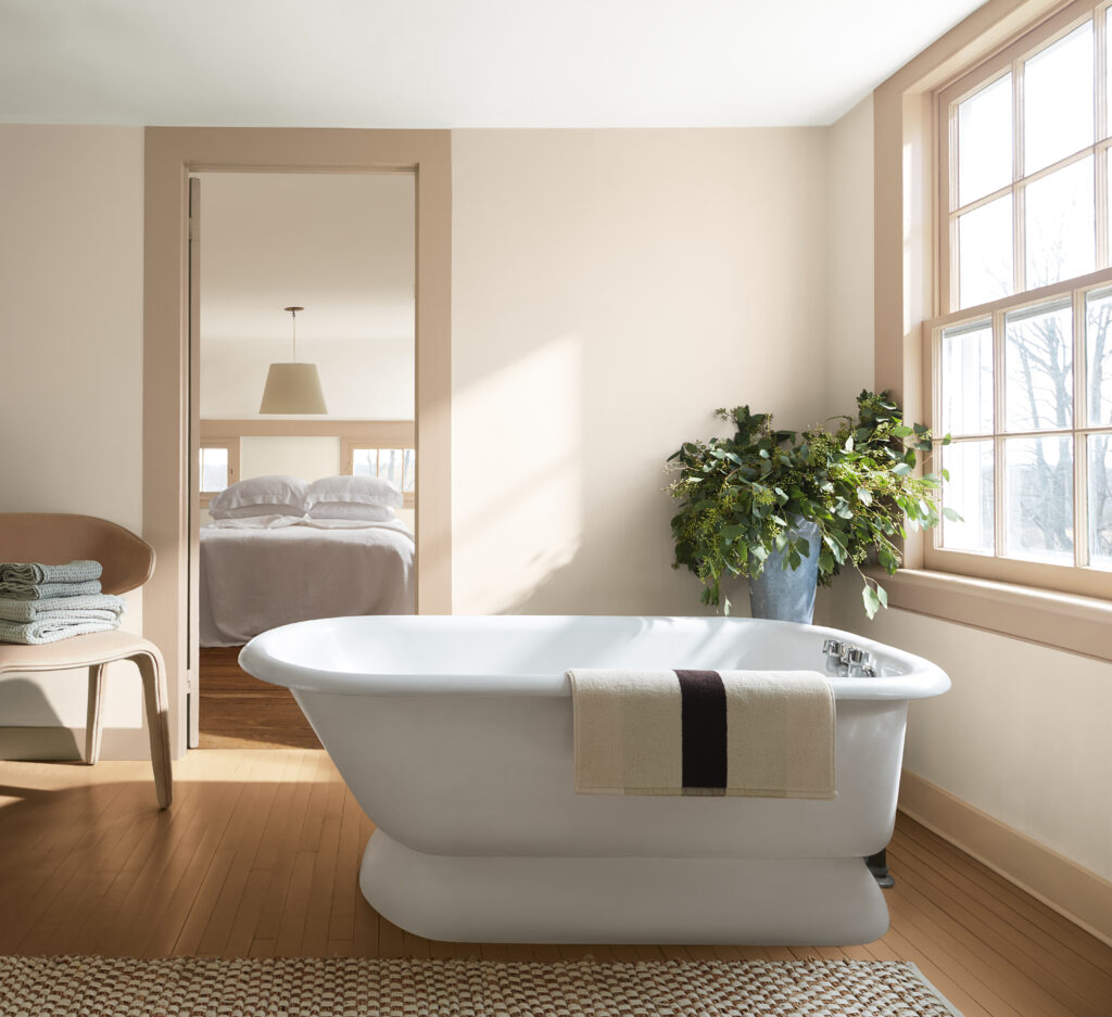 A bathroom painted with BM First Crush paint and tan trim