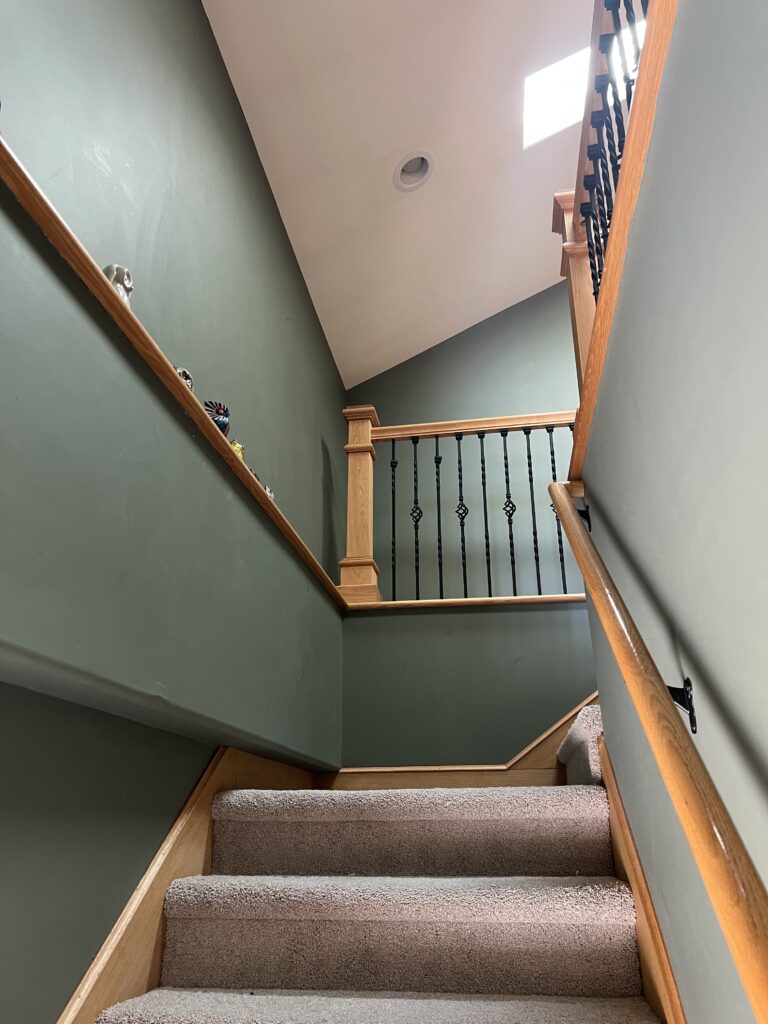 A stairway painted with BM Cambridge Green wall paint.