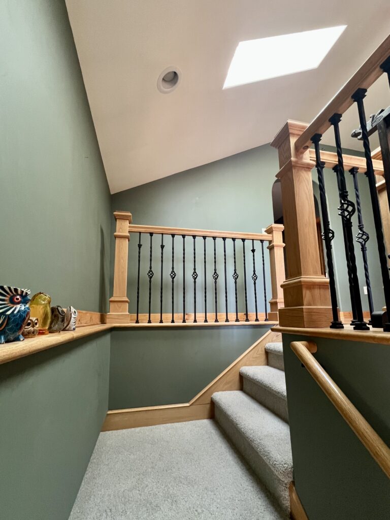 A stairway painted with BM Cambridge Green wall paint. 