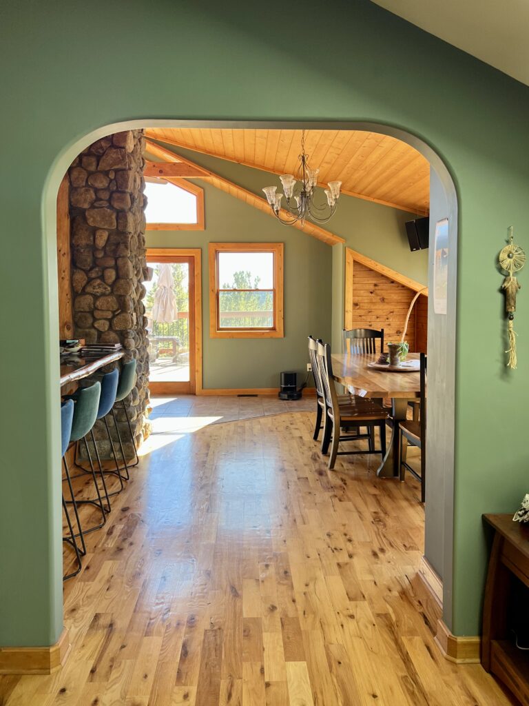 An open concept space painted with BM Cambridge Green wall paint.