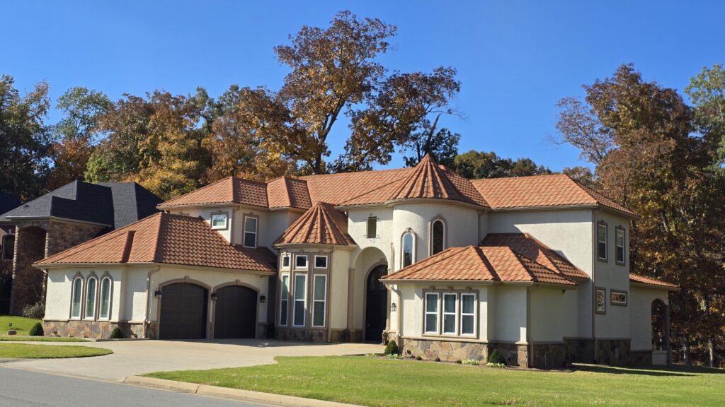 A home painted with SW Grecian Ivory exterior paint, a light warm greige paint color.