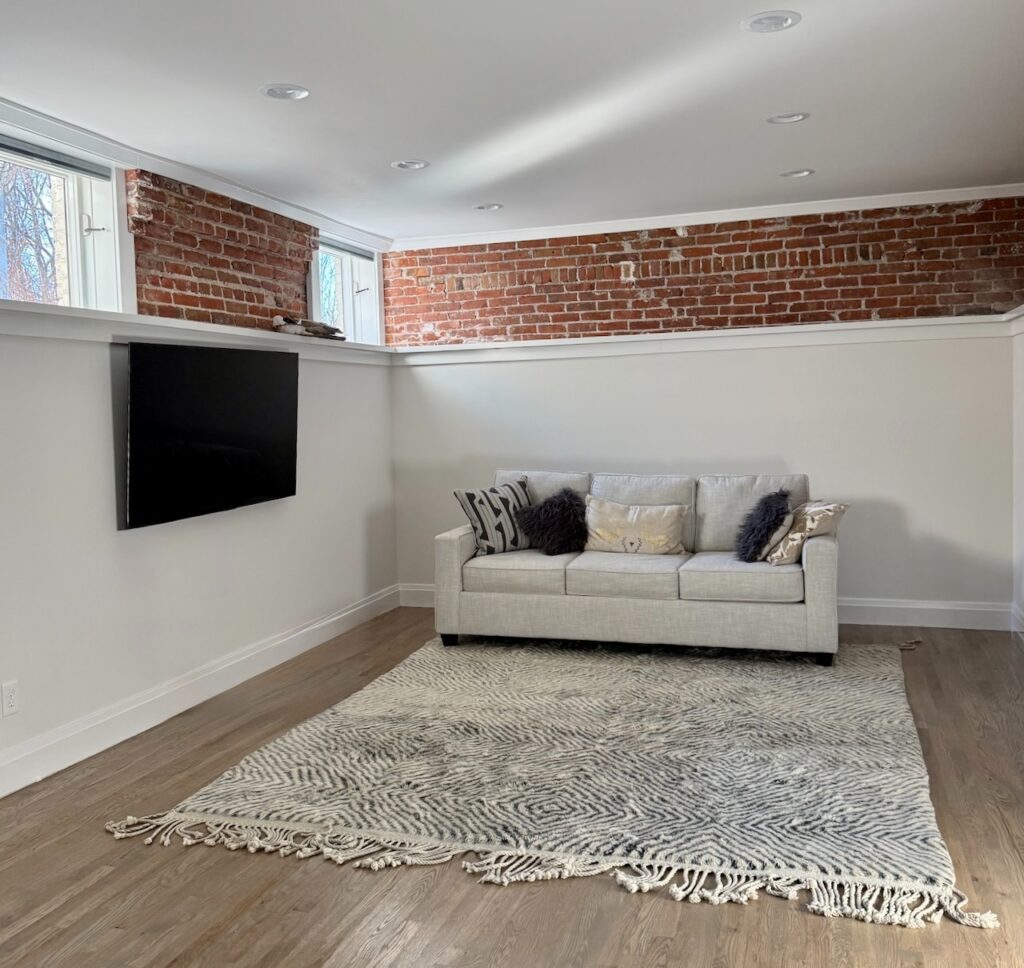 A basement is painted with Benjamin Moore Dove Wing, a complex cream paint color.