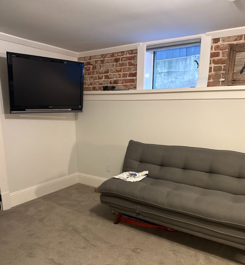 A basement room is painted with Benjamin Moore Dove Wing paint.