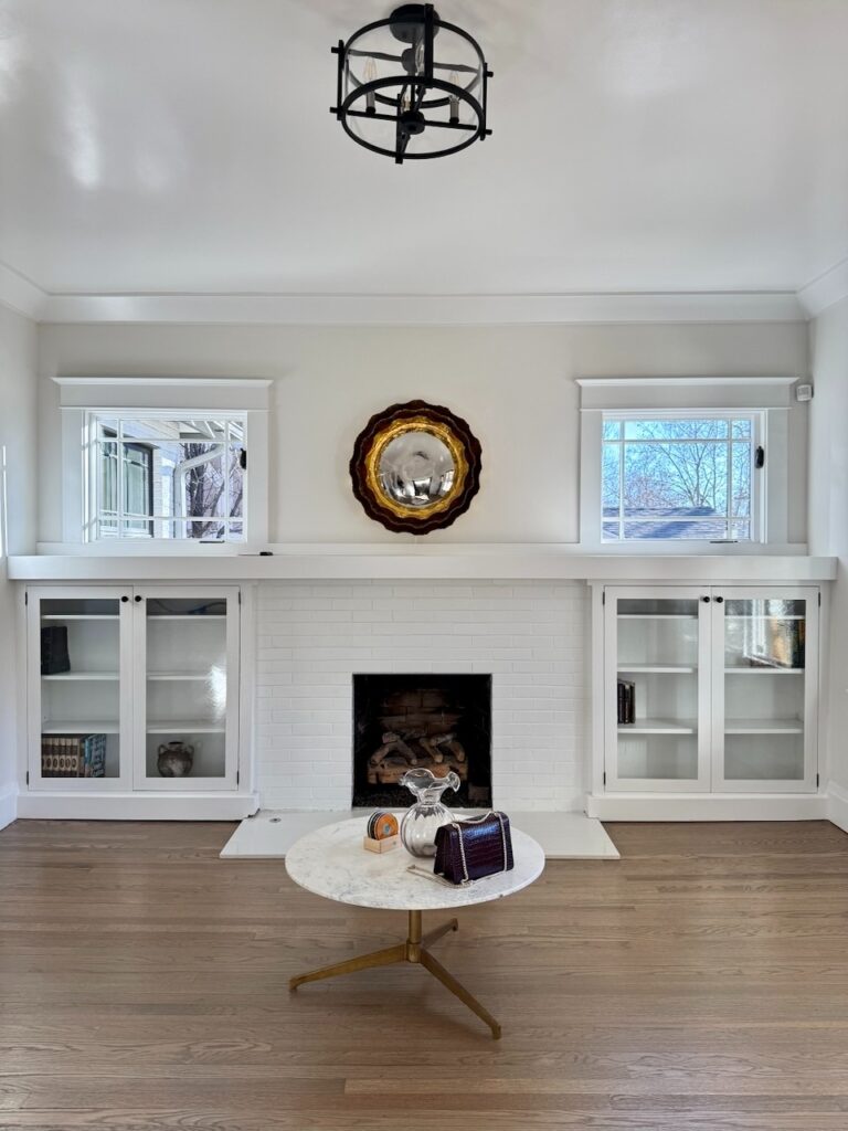 A living room is painted with Benjamin Moore Dove Wing, a warm very light beige paint color with green undertones.