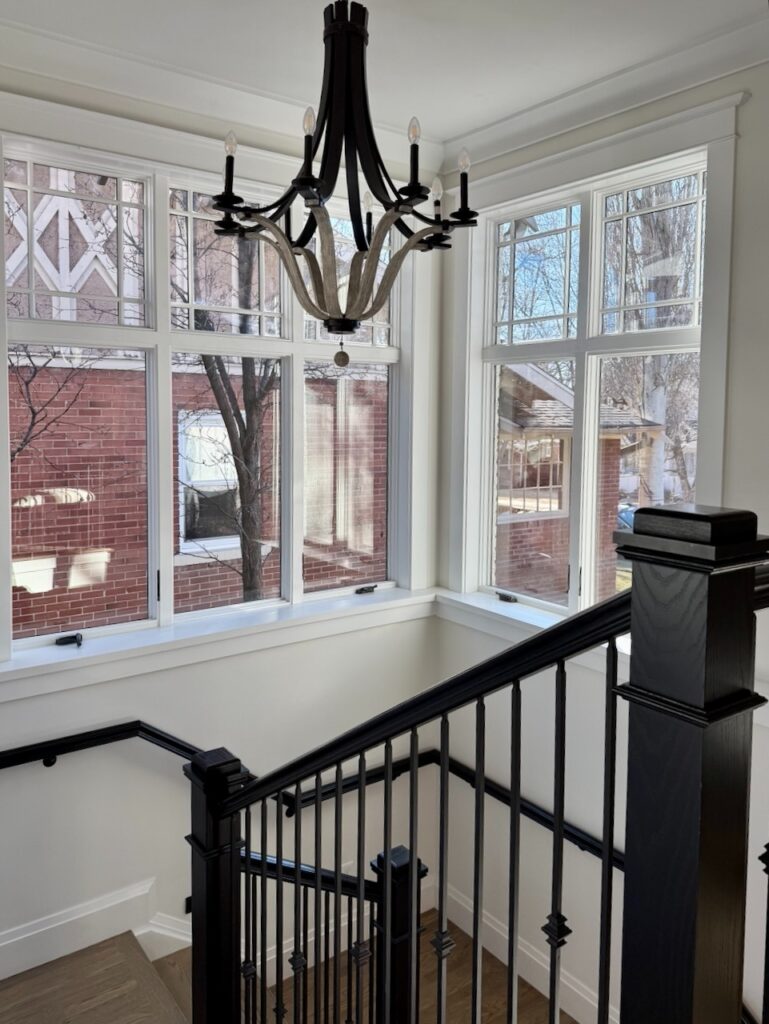 A stairwell is painted with Benjamin Moore Dove Wing, a warm complex cream paint color.