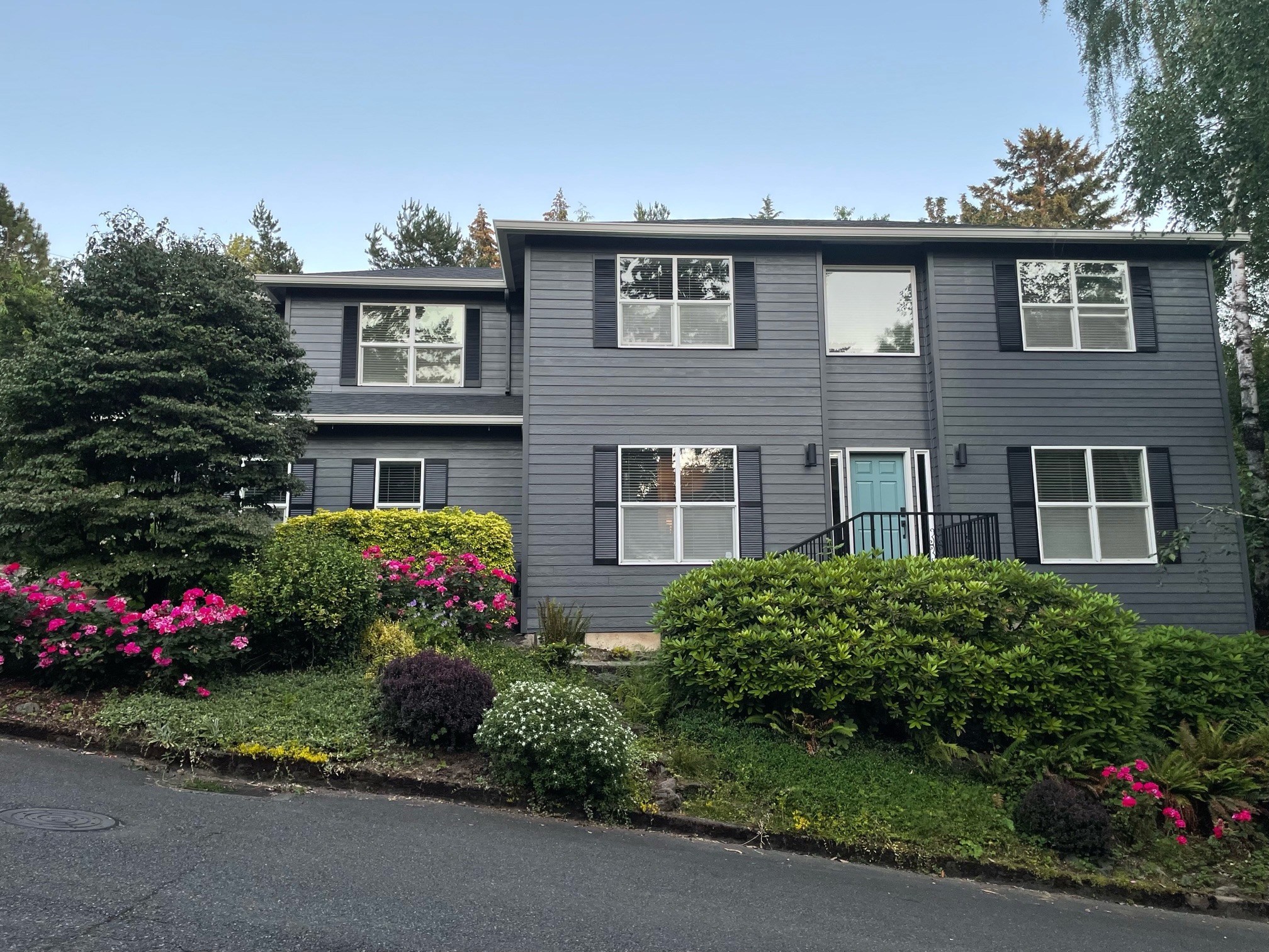 A home features a Sherwin-Williams Peppercorn exterior paint color palette.