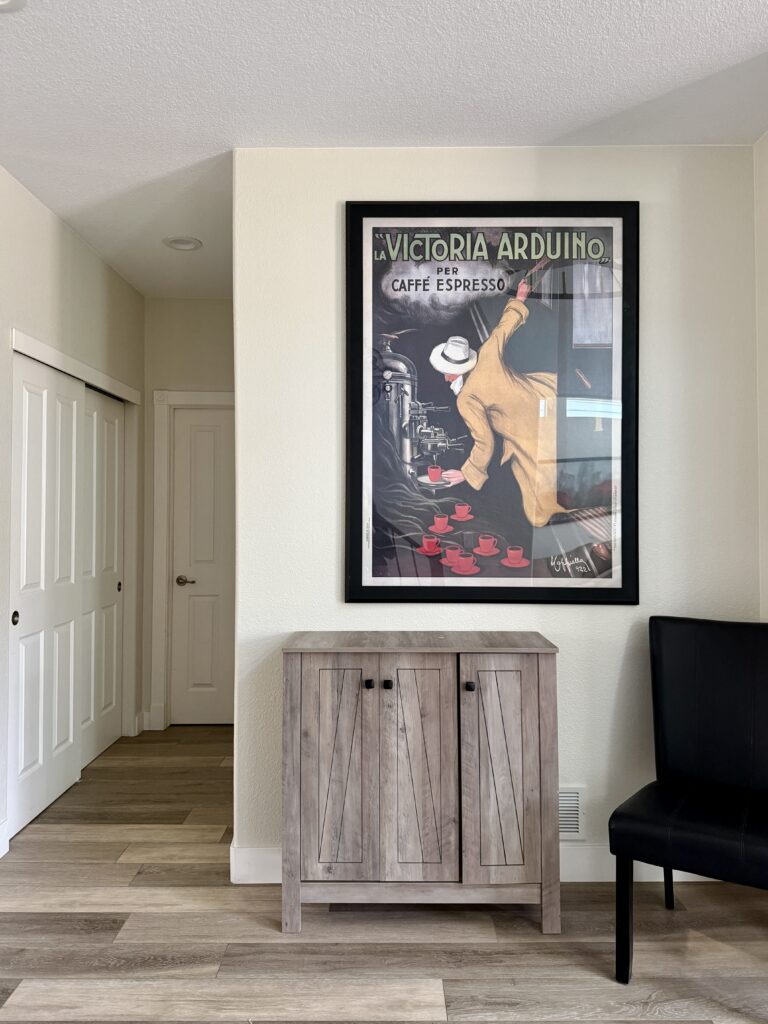 A Ballet White entryway with colorful wall decor.