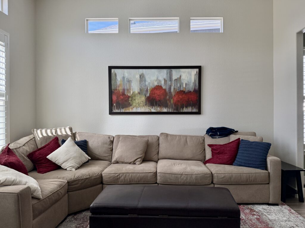 A Ballet White living room with red decor and throw pillows.