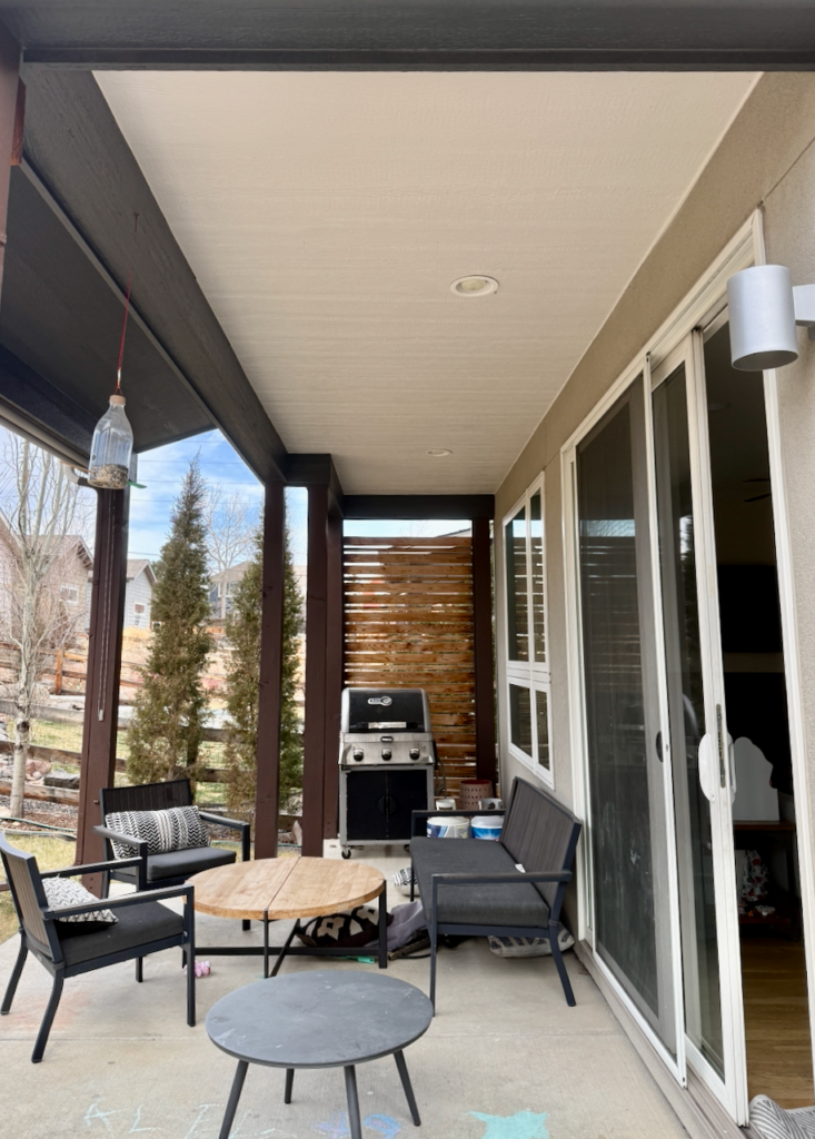 A front porch ceiling is painted with Sherwin-Williams Egret White exterior trim paint.