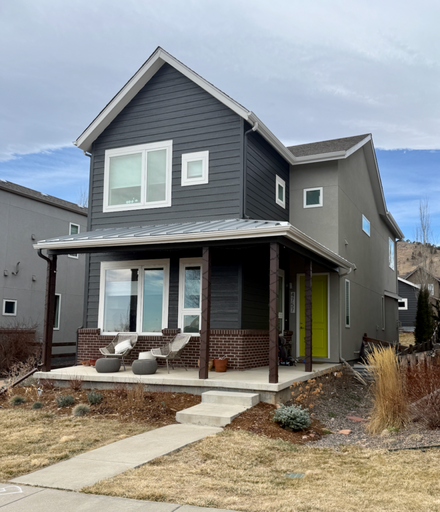 A home features stucco painted with Sherwin-Williams Intellectual Gray exterior paint.