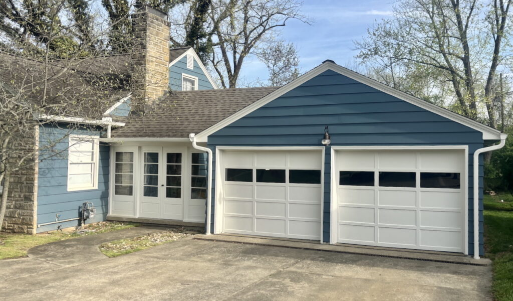 A Sherwin-Williams Waterloo exterior paint color palette with SW Pearly White trim and garage doors.