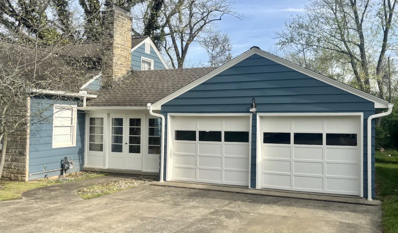 A Sherwin-Williams Waterloo exterior paint color palette with SW Pearly White trim and garage doors.