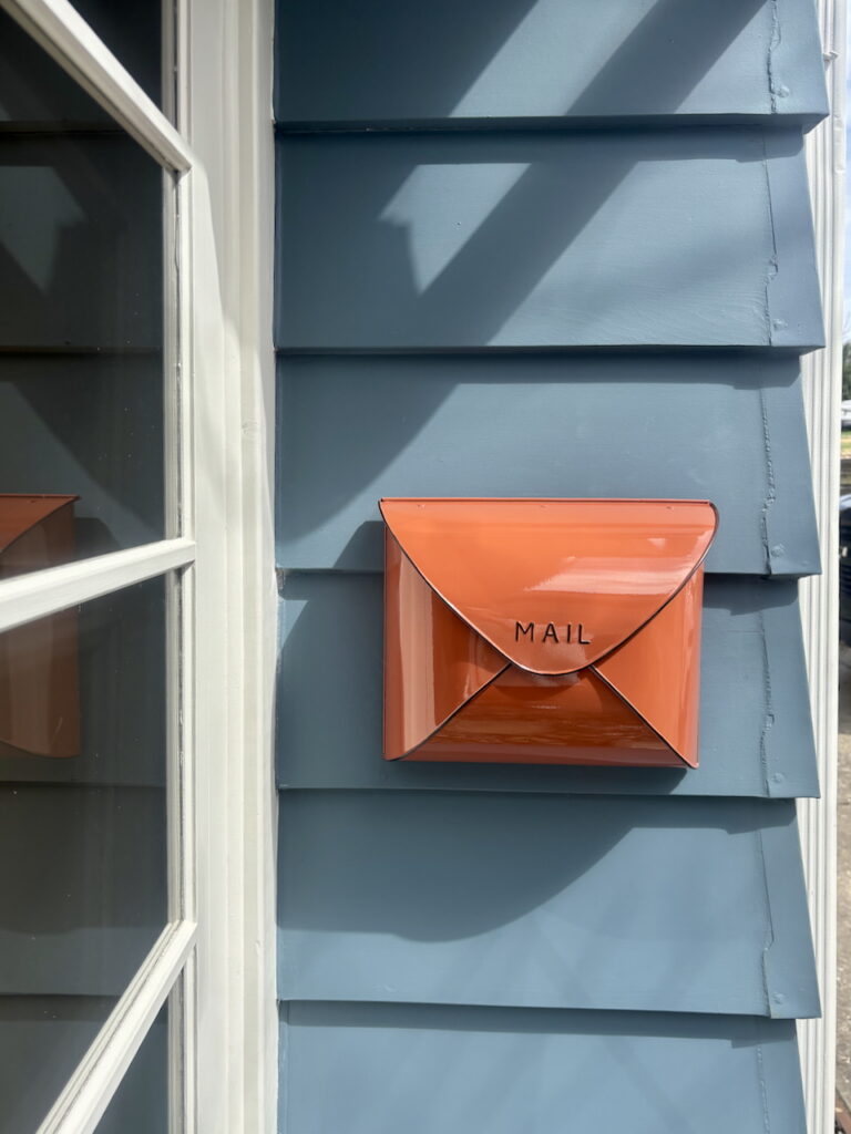 A home with SW Waterloo siding features a red mailbox.