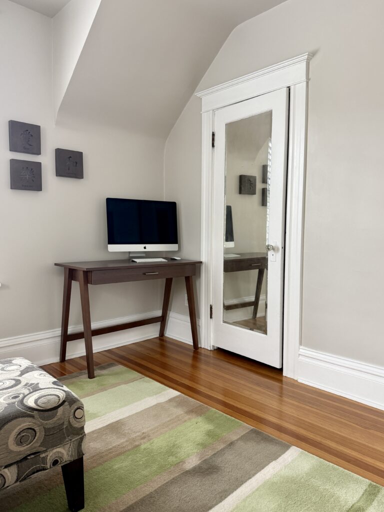 A Benjamin Moore Pale Oak bedroom with slanted ceilings and color drenched walls and ceiling.