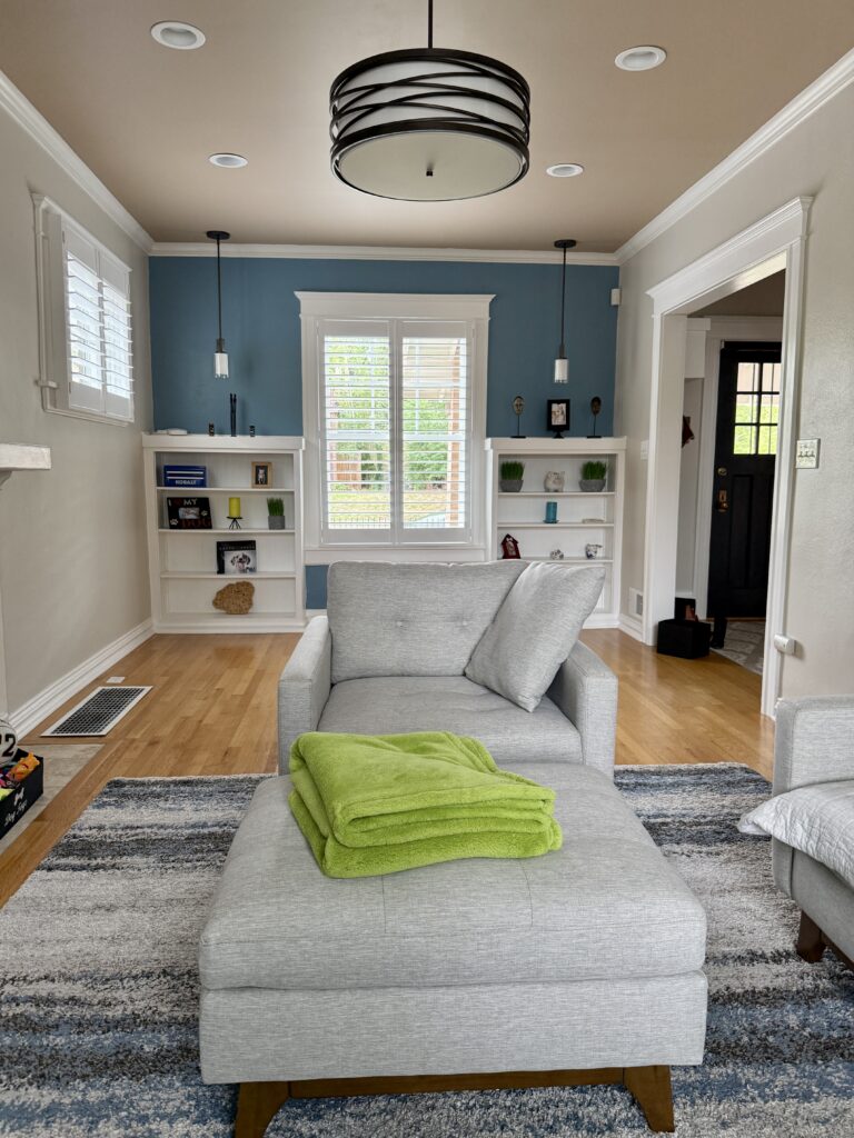 A living room features a BM Buckland Blue accent wall with BM Pale Oak walls and a beige ceiling