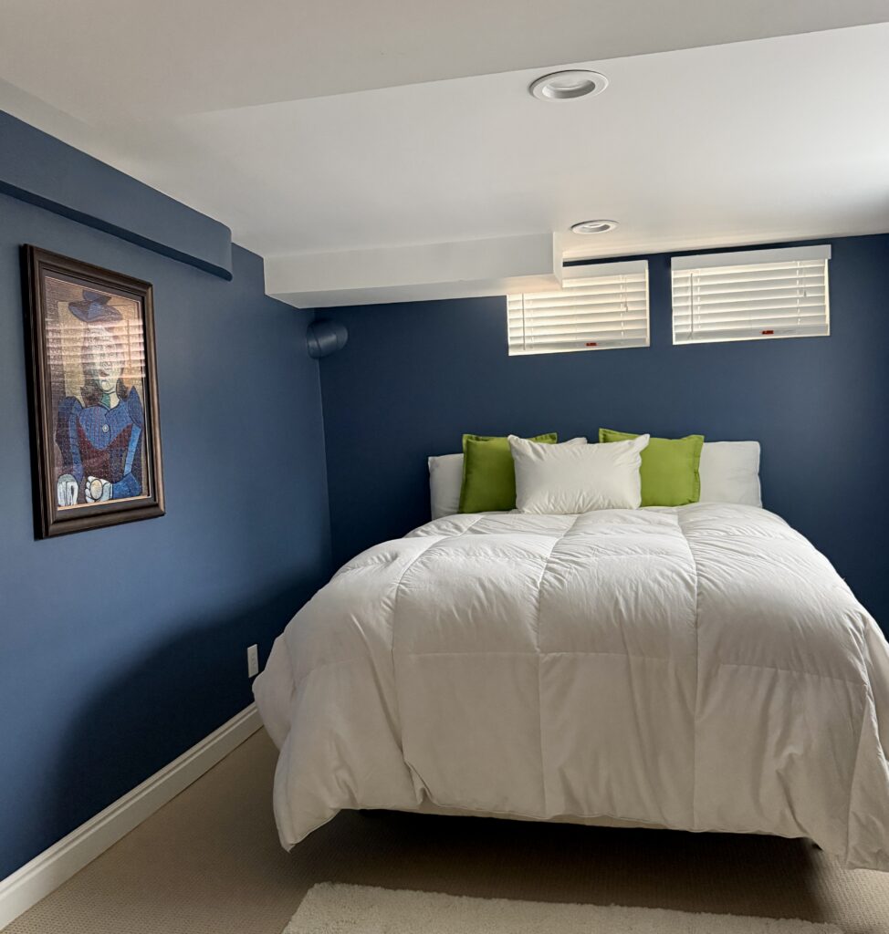 A basement bedroom painted with BM Kensington Blue