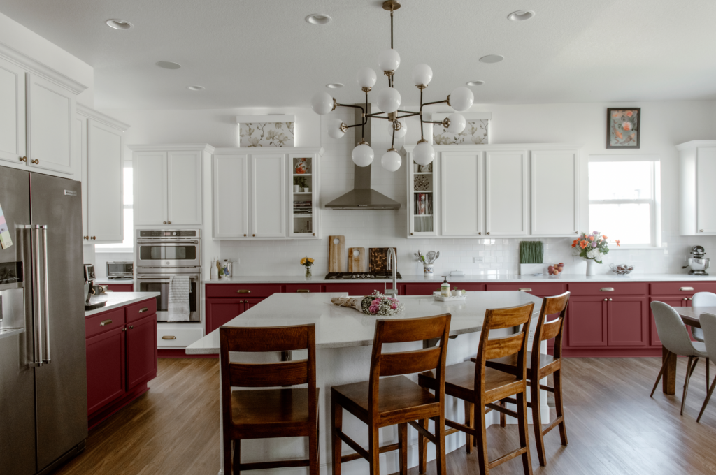 A kitchen featuring white upper cabinets and Benjamin Moore Plum Raisin lower cabinets.
