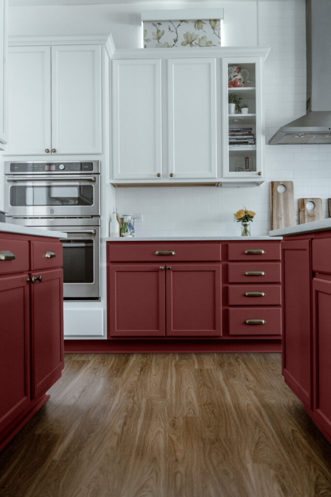 A view of a kitchen with white upper cabinets and Plum Raisin lower cabinets.