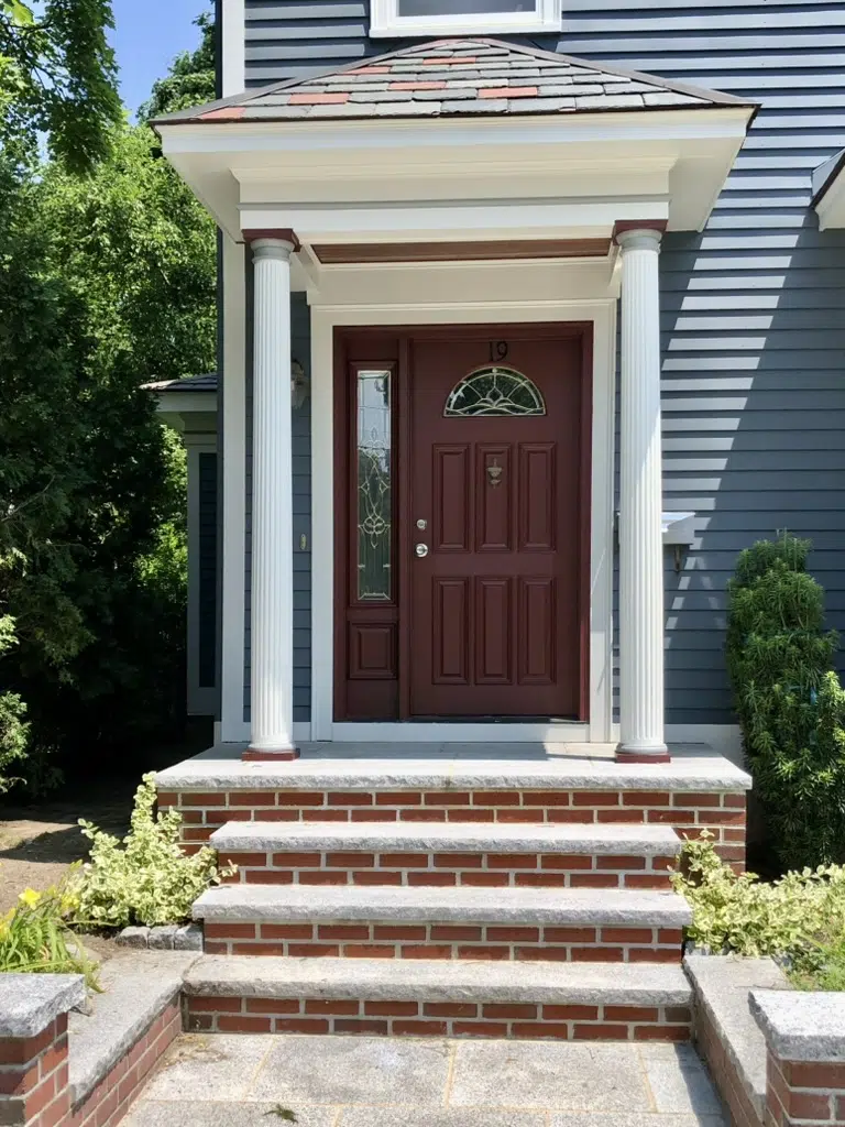 An SW Sommelier front door is pictured along SW Grays Harbor siding and red brick steps.
