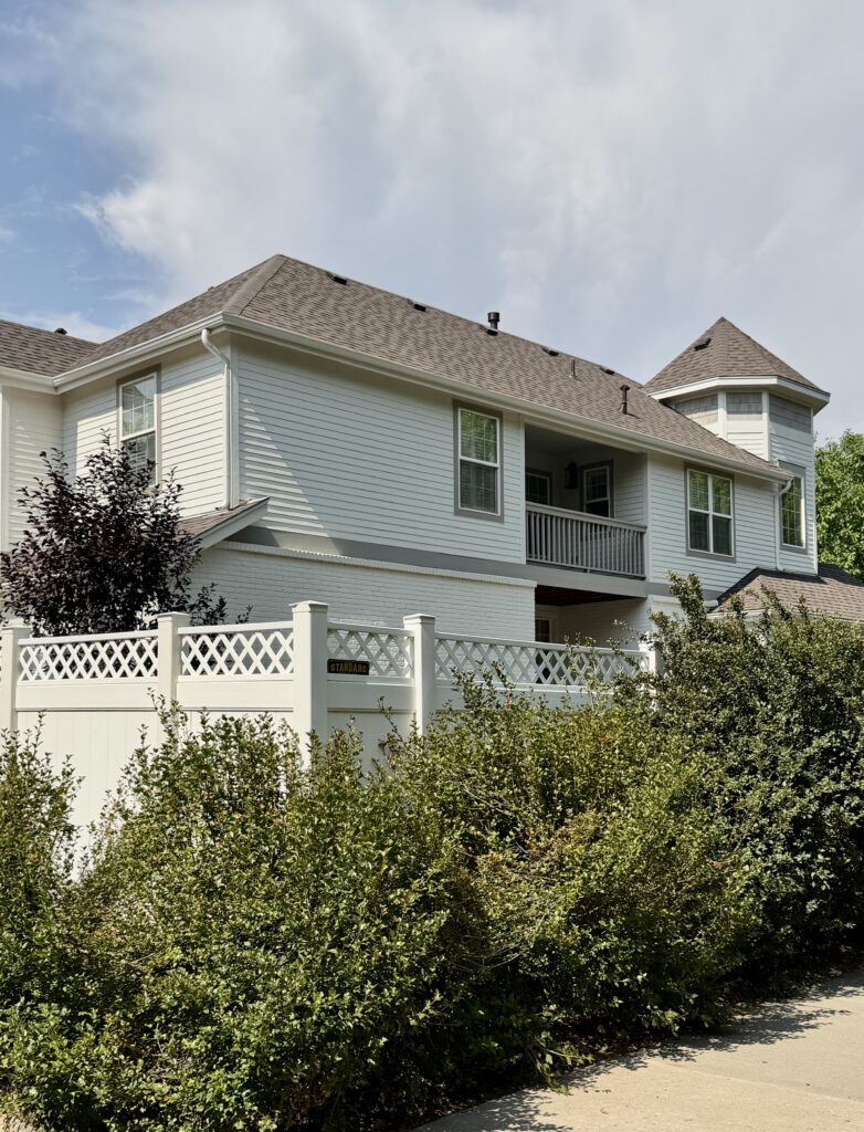 A home features SW White Duck exterior with SW Mega Greige trim.