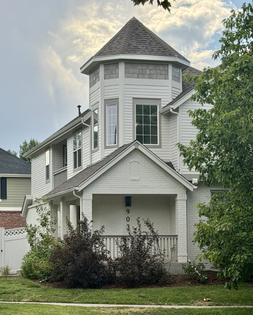 A home featuring a Sherwin-Williams White Duck exterior color palette with Mega Greige trim.