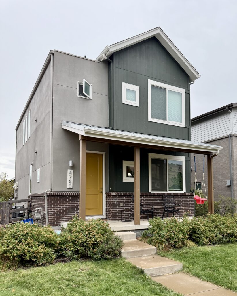 Photo of exterior painted with SW Laurel Woods siding and Bosc Pear front door, with burgundy brick