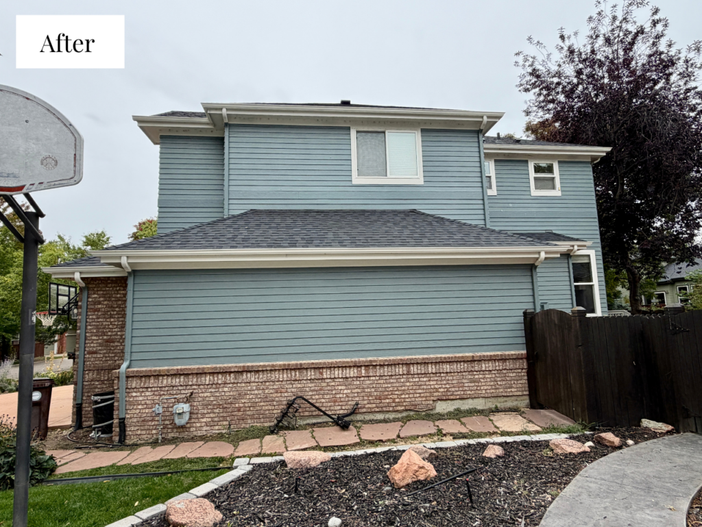 A home painted with Benjamin Moore Apollo Blue exterior paint with red brick finish.