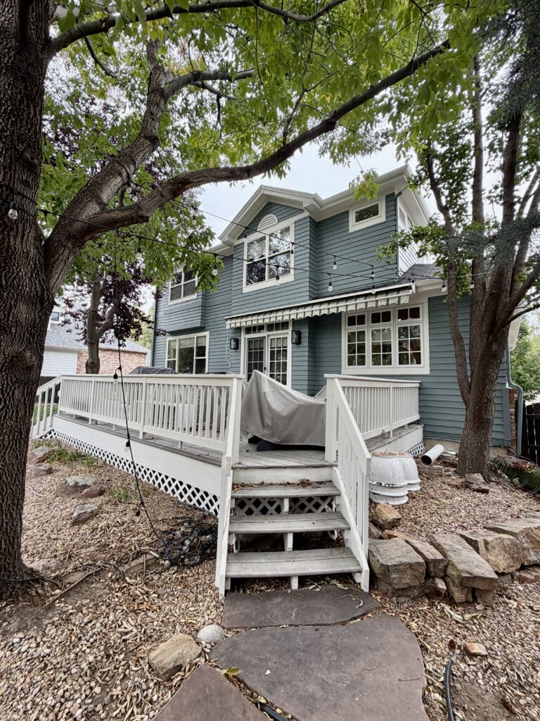 A home painted with BM Apollo Blue and Sherwin-Williams Pearly White exterior trim.
